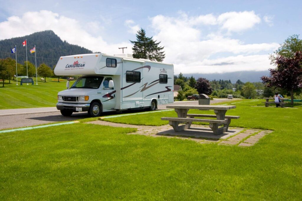 An RV parked for free at a rest stop