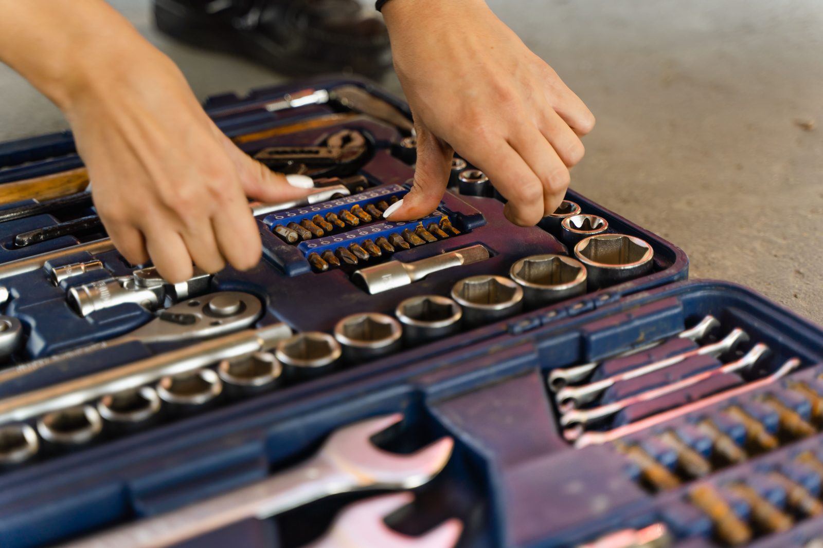 Open tool case with sockets and wrenches laid out in order